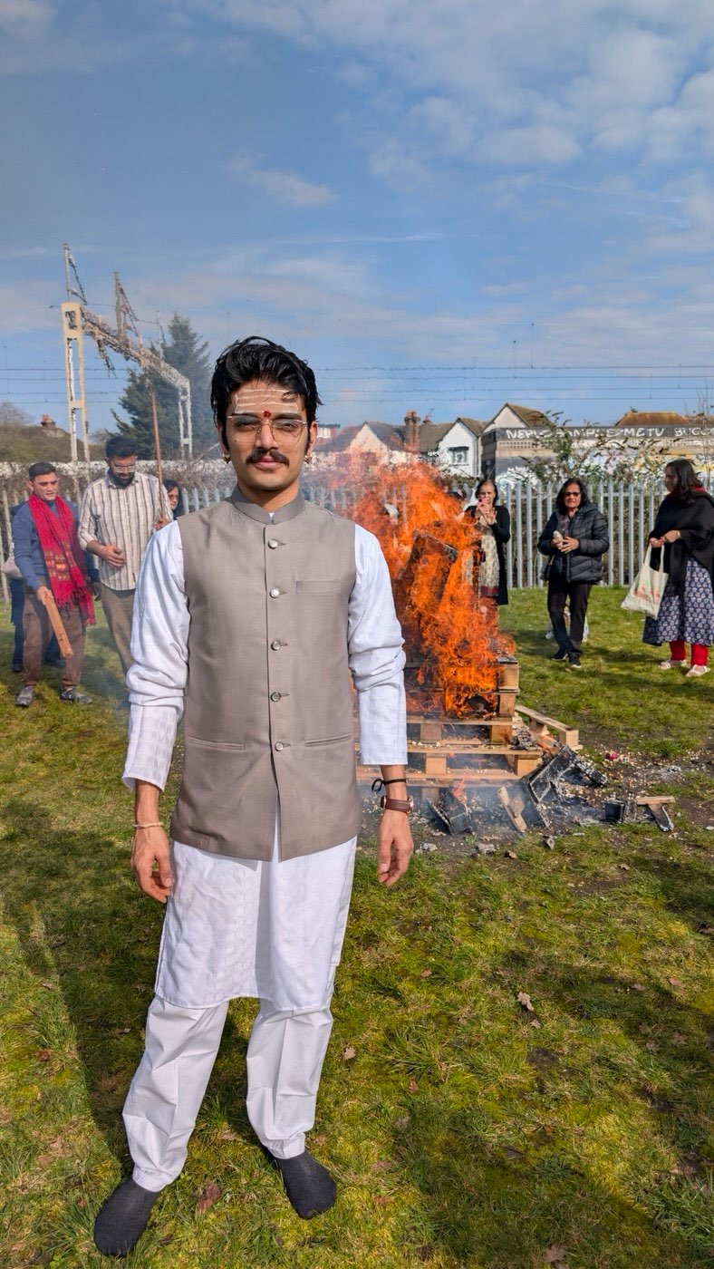 Portrait of Parth Bhatt in a white kurta and grey waistcoat, standing outdoors