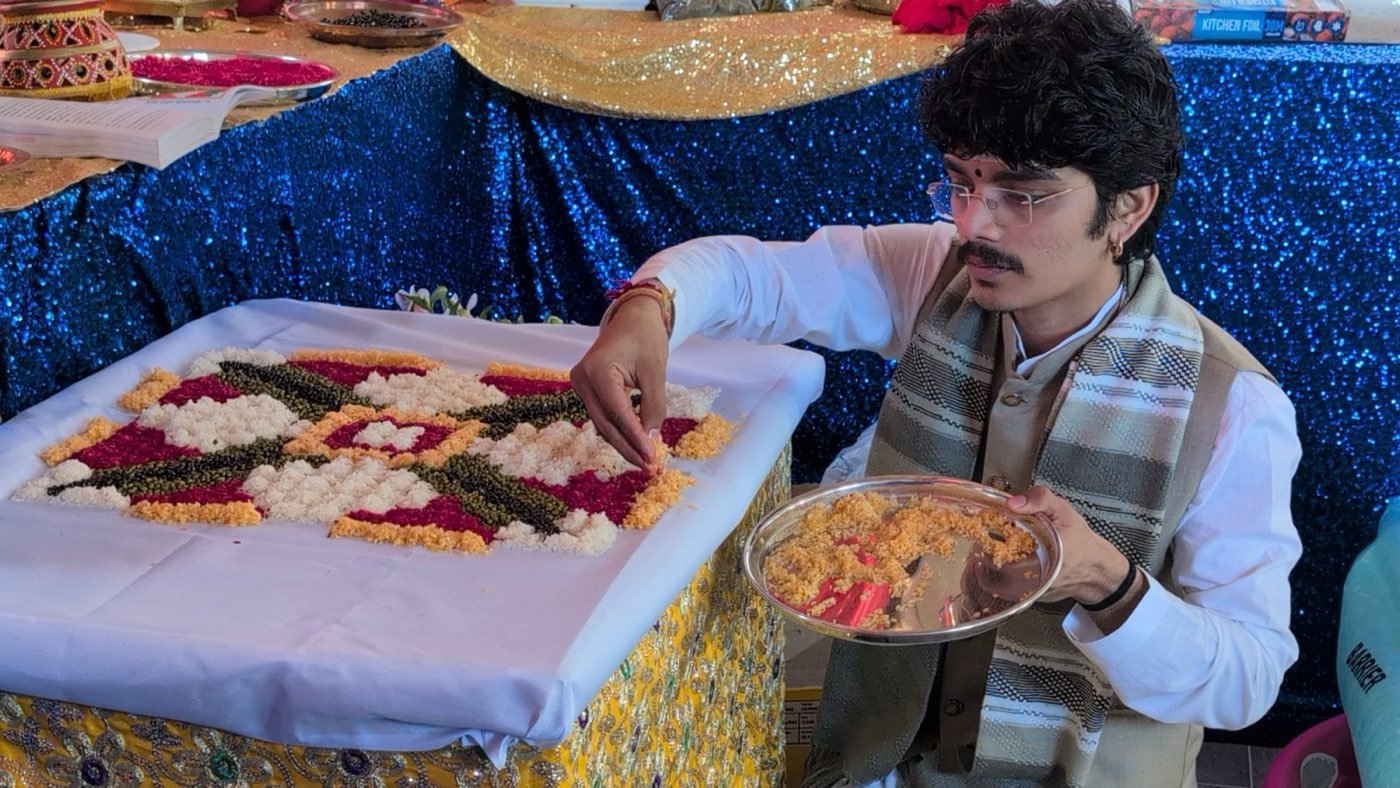Parth Bhatt laying out coloured grains for a puja