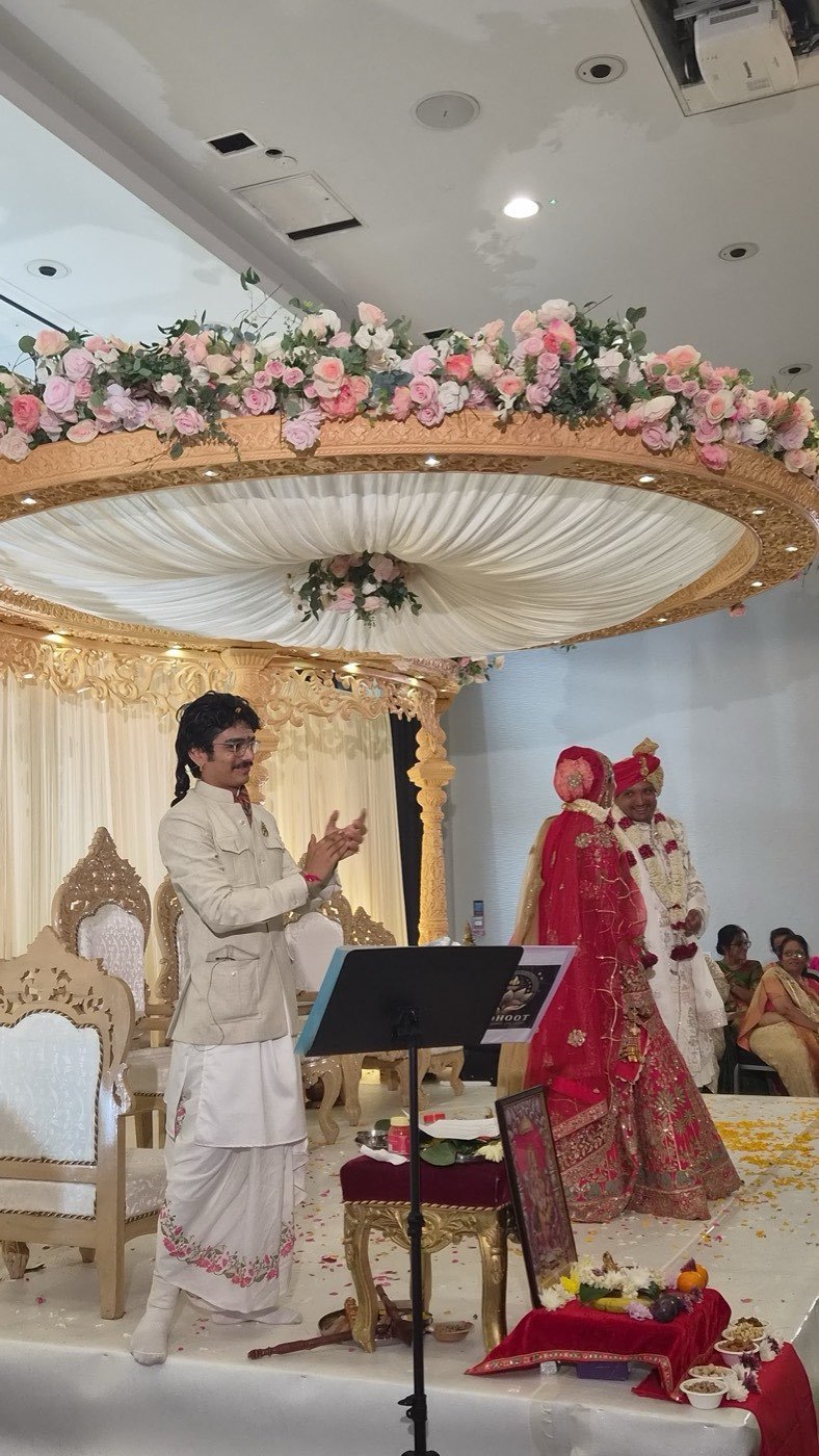 Parth Bhatt leading a wedding ceremony under a floral mandap